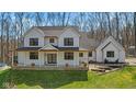 Stunning two-story modern farmhouse exterior featuring a welcoming porch and a well-manicured lawn at 1037 E Woodall Ct, Martinsville, IN 46151