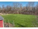 View of the huge yard showing the fence line and well manicured lawn at 11124 Deer Valley Dr, Indianapolis, IN 46229