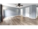 Bright and spacious bedroom with hardwood floors, ceiling fan, neutral gray paint, and a double door closet at 11124 Deer Valley Dr, Indianapolis, IN 46229