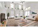 Bright, airy living room with hardwood floors, vaulted ceilings and decor shelves above entry and windows at 11124 Deer Valley Dr, Indianapolis, IN 46229