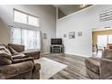 Bright living room with vaulted ceilings, neutral decor, and wood laminate flooring at 11124 Deer Valley Dr, Indianapolis, IN 46229