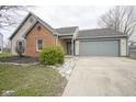Charming single-story home features a brick facade, neutral siding and attached garage at 1163 Randall Way, Brownsburg, IN 46112