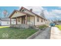 Street view of a quaint home with a covered porch and a side driveway at 12125 Broadway St, Indianapolis, IN 46236