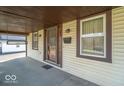 Covered front porch with a storm door and ample natural light at 12125 Broadway St, Indianapolis, IN 46236