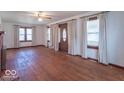 Spacious living room with hardwood floors, large windows, and natural light at 12125 Broadway St, Indianapolis, IN 46236