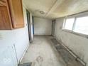 Interior view reveals an empty room featuring basic cabinetry and a window at 1237 N Sheffield Ave, Indianapolis, IN 46222