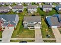 Aerial view of suburban two-story home with neatly manicured lawn, attached two-car garage, and surrounding neighborhood at 1279 Windswept Dr, Greenwood, IN 46143