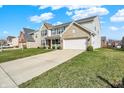Suburban two-story home with brick and vinyl siding, an attached two-car garage, and a neatly manicured front lawn at 1279 Windswept Dr, Greenwood, IN 46143