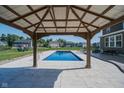 View from inside the gazebo to the rectangular pool, patio and backyard at 12988 Fernie Cir, Fishers, IN 46037