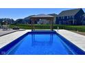 Inviting backyard pool with a gazebo, perfect for relaxation and entertaining guests at 12988 Fernie Cir, Fishers, IN 46037