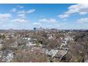 Expansive neighborhood aerial view of homes with a city skyline backdrop on a sunny day at 1351 S Belmont Ave, Indianapolis, IN 46221
