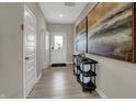 Bright entryway with gray vinyl flooring and a decorative display table with modern art at 15310 Swallow Falls Way, Fishers, IN 46037