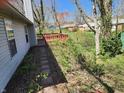 Backyard view with a small wooden deck and brick pathway surrounded by greenery, providing a private outdoor space at 1657 Park Terrace Ct, Indianapolis, IN 46229