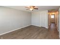 Spacious bedroom with clean gray walls, modern ceiling fan, wood-look flooring, and ample closet space at 1665 South Dr, Columbus, IN 47203
