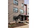 Modern brick condo with front door entry featuring dark trim and landscaping at 1811 Livery Way, Indianapolis, IN 46202