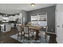 Inviting dining area featuring a wood table, white chairs, and a stylish blue patterned rug at 1896 Woodland Parks Dr, Columbus, IN 47201