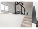 Open-concept living room with sleek railing, neutral paint, and modern decor on the second floor at 3153 Stillmeadow Dr, Indianapolis, IN 46214