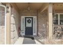 Inviting front porch featuring a decorative front door with wreath and seating, perfect for relaxing at 34 David Ln, Indianapolis, IN 46227