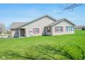 A well-maintained single-story home with brick accents, shutters, and a green lawn at 3925 Oak Harbor Ln, Indianapolis, IN 46237