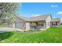 Attractive single-story home with brick and siding, complemented by a neat front yard and landscaping at 3925 Oak Harbor Ln, Indianapolis, IN 46237