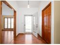 Inviting entryway with wood floors, closet and view of large living room at 4411 W Friar Dr, Muncie, IN 47304