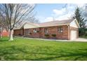 Brick home with attached two car garage and well maintained lawn at 4411 W Friar Dr, Muncie, IN 47304
