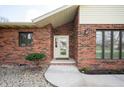 Close up of the front entrance with charming brickwork and updated trim at 4411 W Friar Dr, Muncie, IN 47304