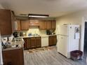 Functional kitchen featuring wood cabinets, modern appliances, and durable floors, providing ample space for cooking at 445 E 1000 N, Alexandria, IN 46001