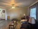 Cozy living room featuring a ceiling fan, large window, and comfortable seating, perfect for relaxing at 445 E 1000 N, Alexandria, IN 46001