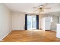 Cozy living area with hardwood floors, sliding glass door, and a ceiling fan at 5061 Sylvan Rd, Indianapolis, IN 46228