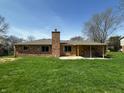 This property features a nice backyard with mature trees and a brick chimney at 5630 S Cladwell Dr, Pendleton, IN 46064