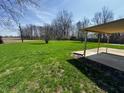 A very large grassy backyard with a covered patio offers a peaceful retreat at 5630 S Cladwell Dr, Pendleton, IN 46064