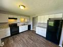 Modern kitchen with new white cabinetry, granite counters, and new black appliances at 5630 S Cladwell Dr, Pendleton, IN 46064