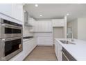 Gourmet kitchen offers stainless steel appliances, modern cabinetry, quartz countertops, and recessed lighting at 5653 Stetson Dr, Whitestown, IN 46052