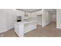 Modern kitchen featuring white cabinets, stainless appliances, quartz counters and center island with breakfast bar at 5653 Stetson Dr, Whitestown, IN 46052