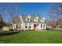 Charming two-story home with landscaped front yard and bright orange front door at 5952 Stafford Rd, Indianapolis, IN 46228