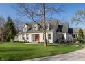 Beautifully landscaped front yard with lush green lawn and white brick two-story home at 5952 Stafford Rd, Indianapolis, IN 46228