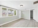 Bright living room with large windows, neutral walls, and modern, light colored flooring at 612 Woodlawn Dr, Anderson, IN 46012