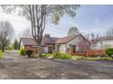 A ranch-style home with brick and siding and a spacious backyard and lovely deck at 6141 Madison Ave, Indianapolis, IN 46227