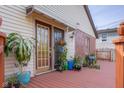 Inviting wooden deck with potted plants and glass-paneled doors to the home at 6141 Madison Ave, Indianapolis, IN 46227