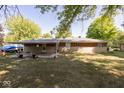 Expansive backyard featuring a covered patio, with a brick and stone facade, perfect for outdoor entertaining at 6144 S Irwin St, Indianapolis, IN 46237
