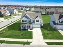 Aerial view of home showcasing well-manicured lawn and long driveway with ample curb appeal at 6767 Sonora Blvd, Brownsburg, IN 46112