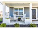 Inviting front porch with rocking chairs, a porch swing, and charming curb appeal at 6767 Sonora Blvd, Brownsburg, IN 46112