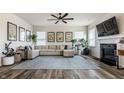 Bright living room with a fireplace, modern decor, neutral sectional, and luxury vinyl flooring at 6767 Sonora Blvd, Brownsburg, IN 46112