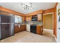 Efficient kitchen layout with stainless steel refrigerator and classic dark-stained cabinetry at 7974 N 500 W, McCordsville, IN 46055