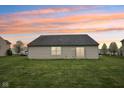 Spacious backyard featuring a large lawn and the exterior of the home with a sliding glass door at 8660 Benjamin Ln, Avon, IN 46123