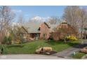 Charming two-story brick home with a well-manicured lawn and landscaping, showcasing its curb appeal at 8939 Spider Bay Ct, Indianapolis, IN 46236