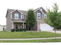 Inviting two-story home with a manicured lawn and a two-car garage at 981 Redwood Dr, Franklin, IN 46131