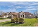 Beautiful two-story home with lush lawn and landscaping at 9877 Wading Crane Ave, Fishers, IN 46055