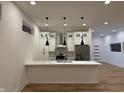 Contemporary kitchen with island, pendant lighting, stainless steel appliances, and custom cabinetry at 1026 St Peter St, Indianapolis, IN 46203
